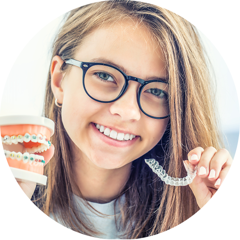 Teen girl holding braces mold and Invisalign